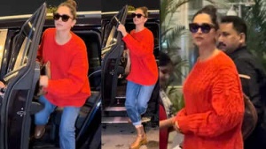 Deepika Padukone keeps it cool in red sweater and denim for airport look; flashes smile before jetting off in style