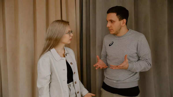 A person avoiding eye contact, indicating discomfort with the conversation